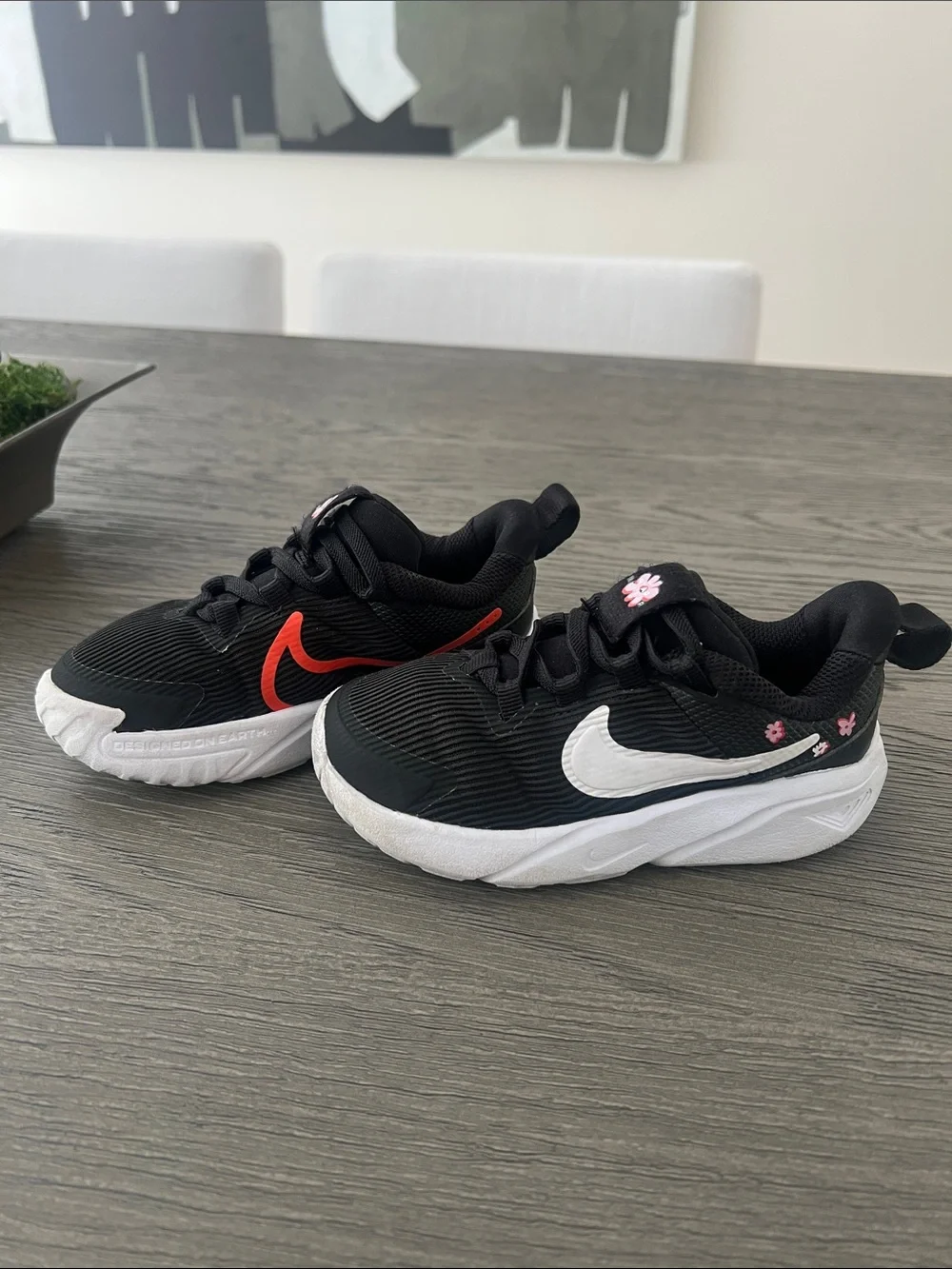 Nike Kids Black Sneakers with White & Red Swoosh and Pink Flower Accents